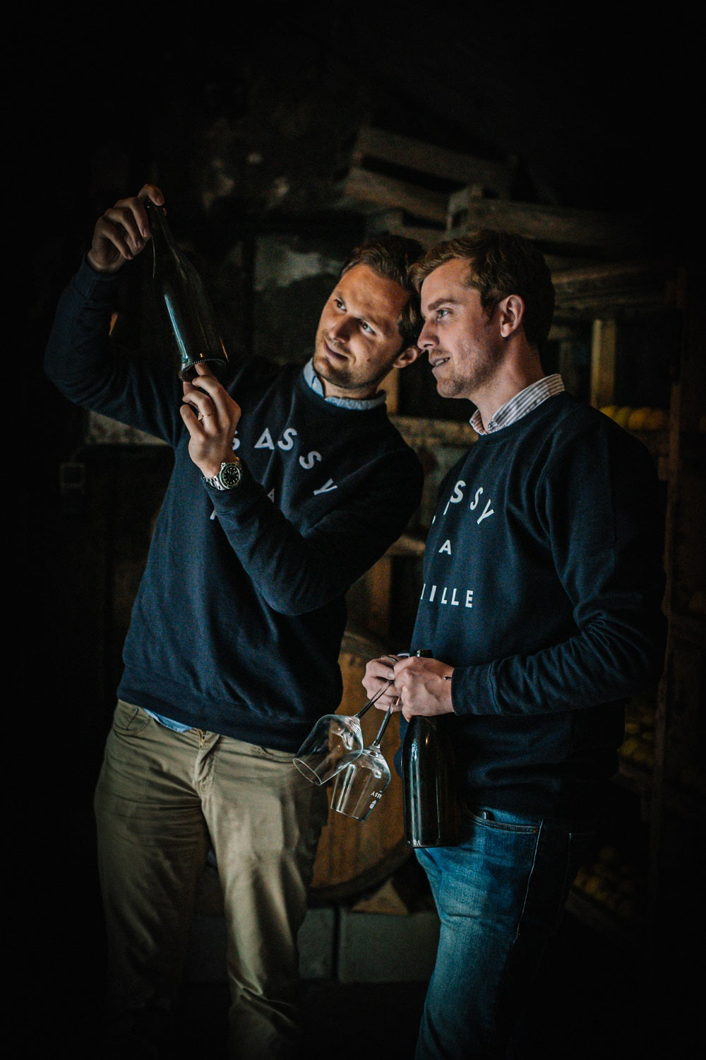 Maison Sassy founders assessing bottle of French cider