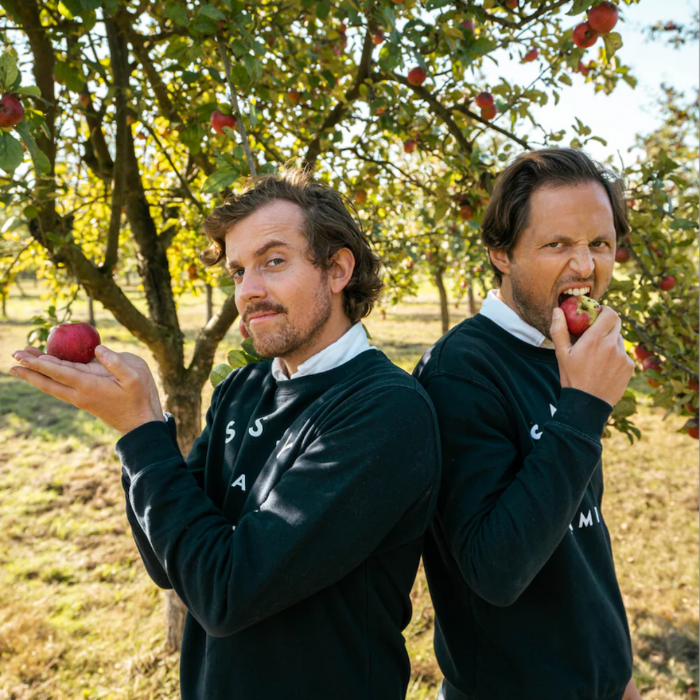 The founders of Maison Sassy eating cider apples