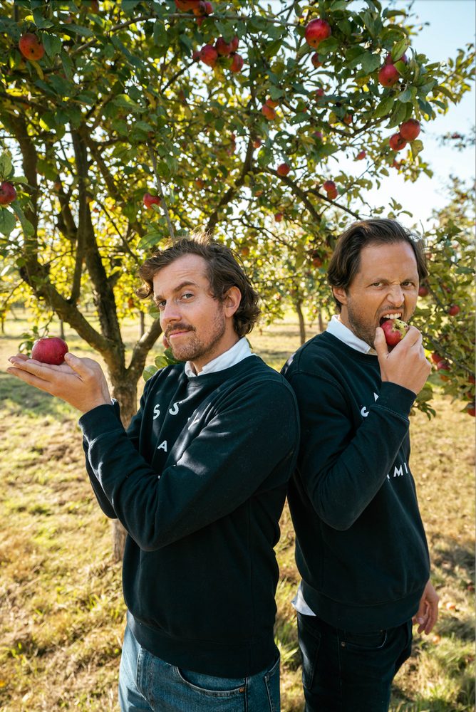 The founders of Maison Sassy eating cider apples